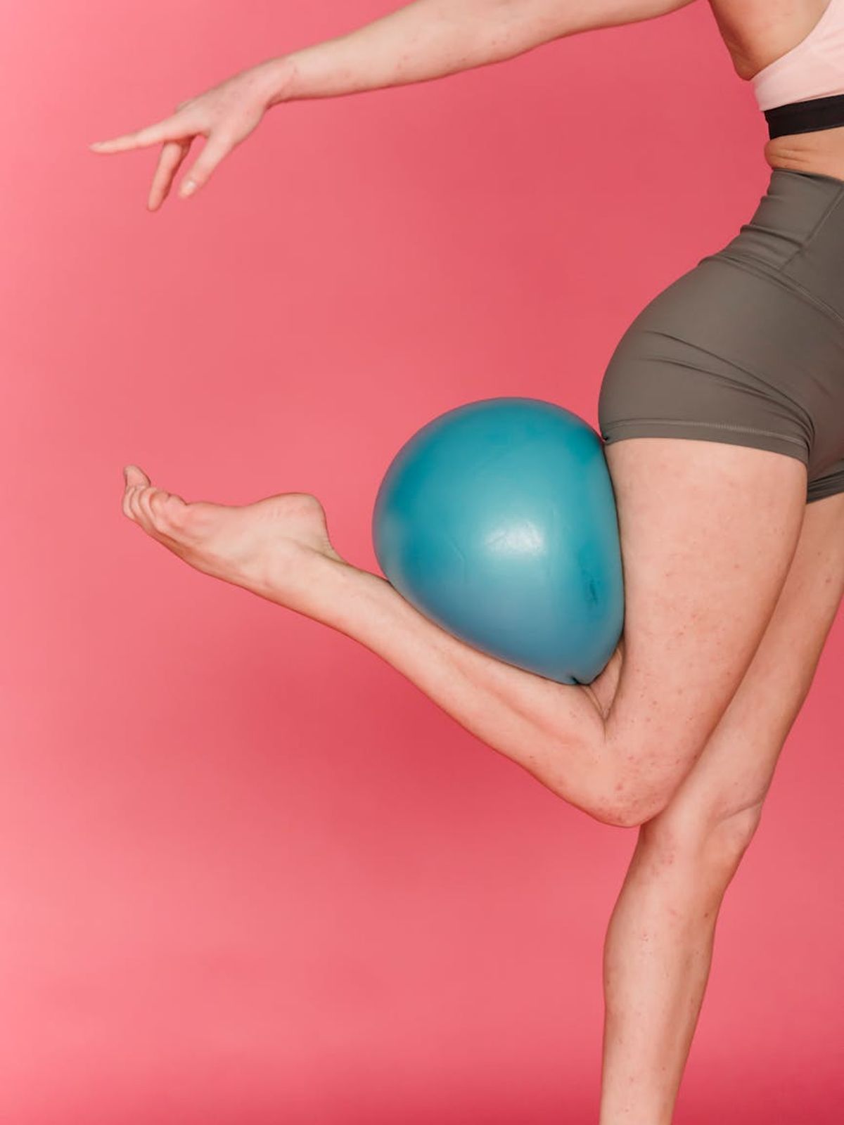 Person doing dynamic exercises in a bright minimalist studio.